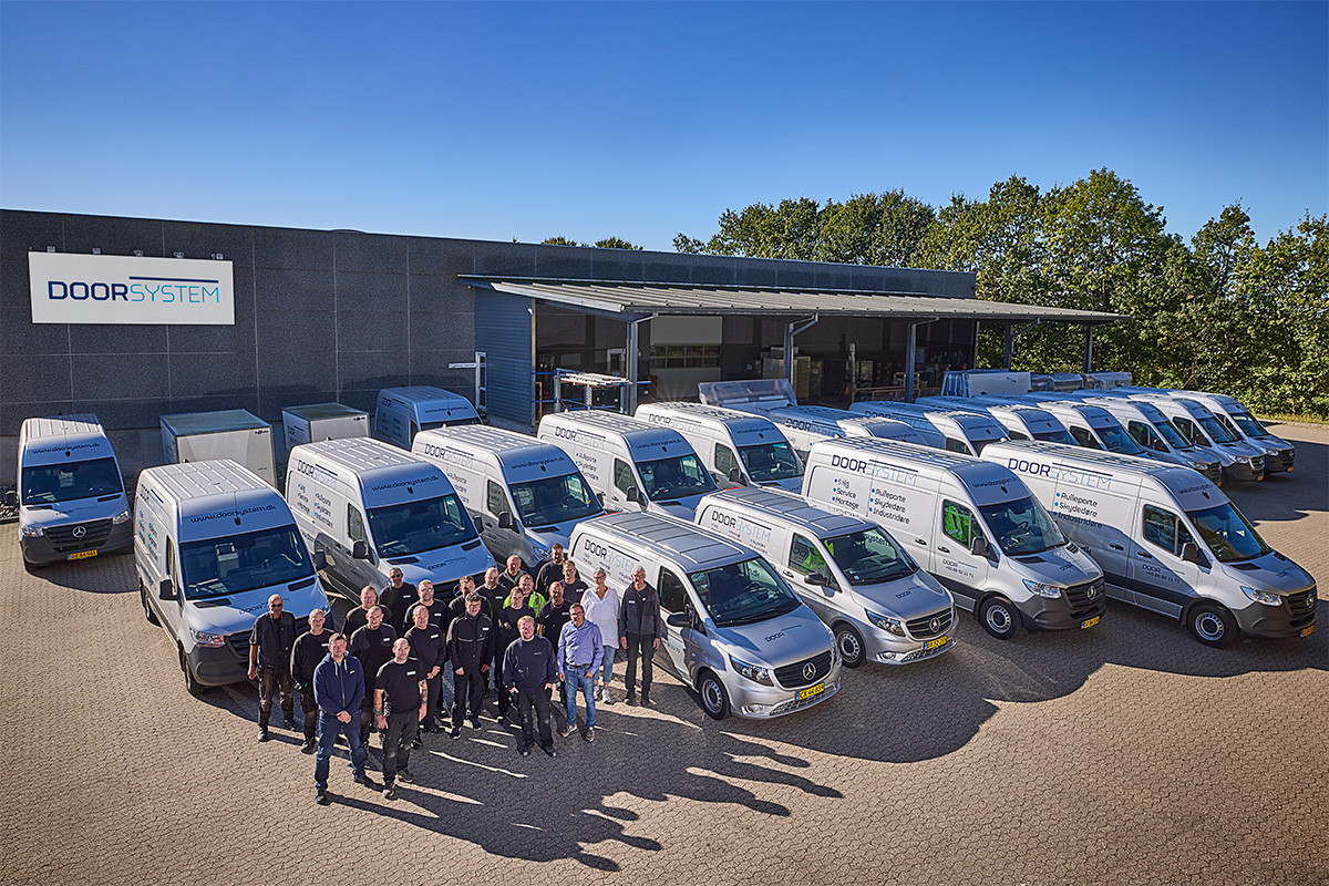 Door System service engineers and service cars in front of the the factory